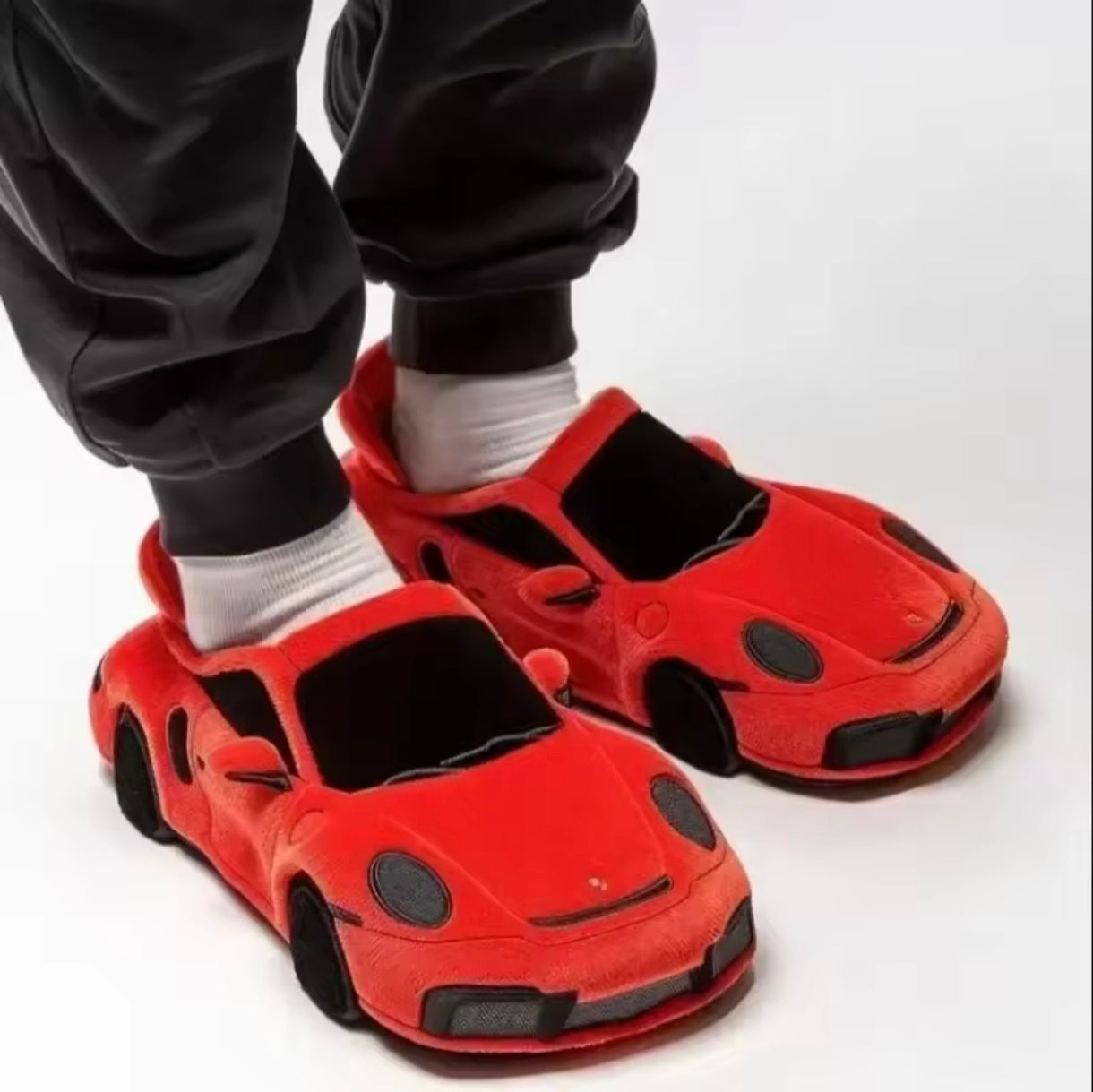 Plush slippers in the shape of a BMW and Porsche.
